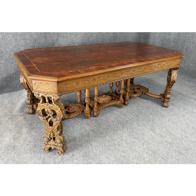 This late 1800s European dining table is crafted from burled walnut and showcases elaborate hand-carved details across the...