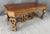 This late 1800s European dining table is crafted from burled walnut and showcases elaborate hand-carved details across the...