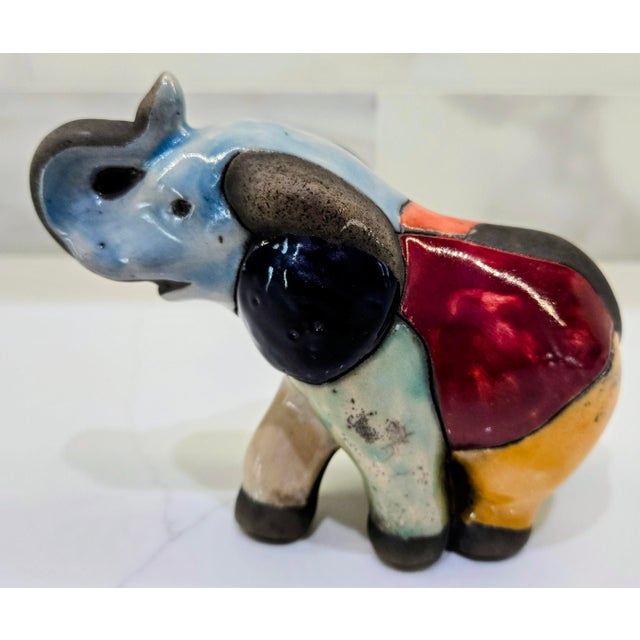 Bring a pop of color and Mexican folk art charm to your decor with this handcrafted ceramic elephant figurine signed...