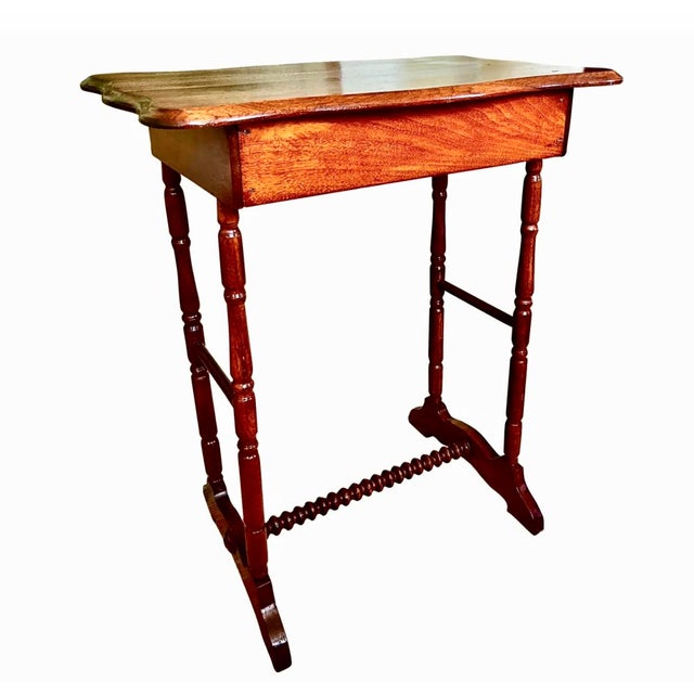 Federal Period trestle table with curved top, bobbin turned stretcher and turned legs. Bullseye carved detail on both...