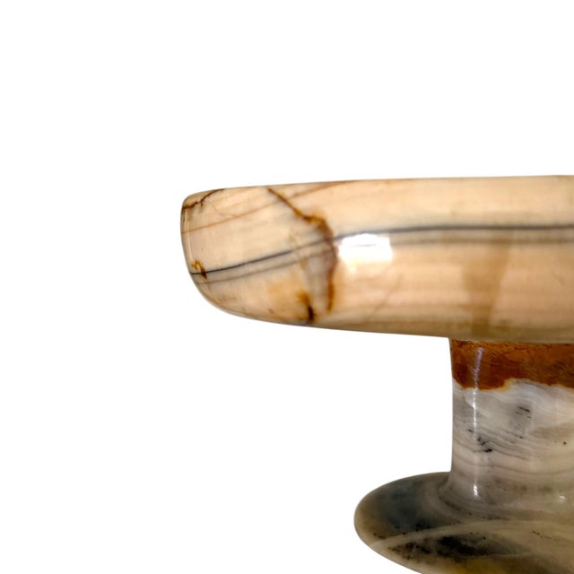 Bring warmth and sculptural elegance to a tabletop with this vintage carved banded onyx pedestal compote. Crafted from...