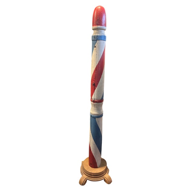 19th c wood red, white and blue barber pole with wood stand. Pole is in excellent condition with bright paint and the...
