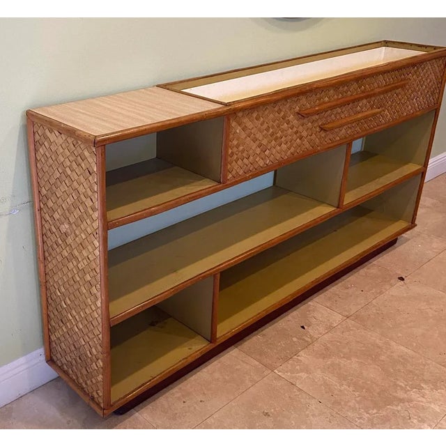 Vintage rattan shelving unit with a built in planter. Herringbone decoration on this very versable cabinet. Can be used in...