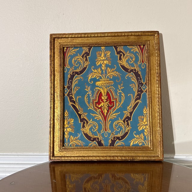 Elegant decorative wall art featuring a richly detailed baroque-inspired design with gold, red, and teal tones. The...