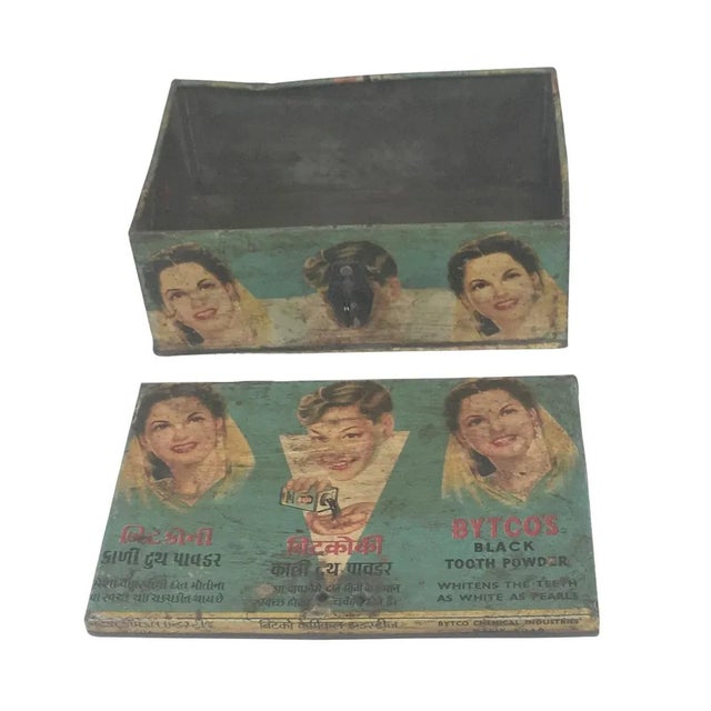 This vintage metal box features a colorful hand painted advertisement of a popular product in Indian culture on the top of...
