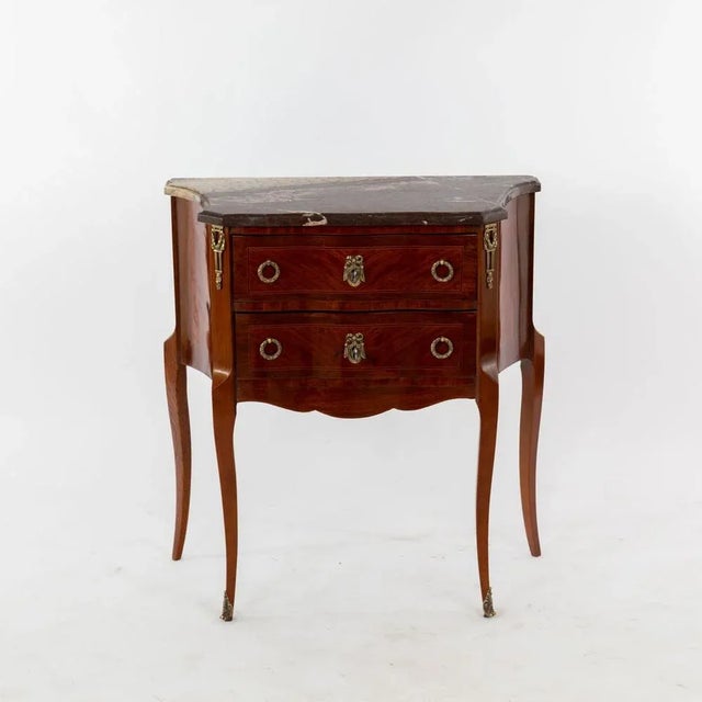 Small night dresser in style of Louis XV at the end of the 19th century. Two drawers with brass handles and fittings....