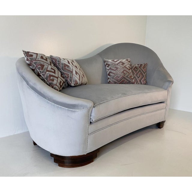 This sofa was produced in Italy in the 50s. The feet are covered in macassar. The sofa is newly upholstered with a gray...