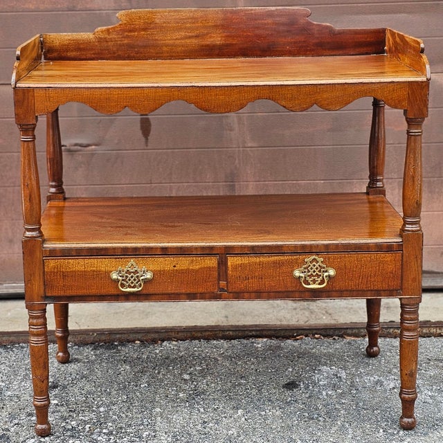 An Early 20th Century Federal Style Mahogany Double Drawers Tiered Wash Stand. Measures 33" in width, 18" in depth and 30"...
