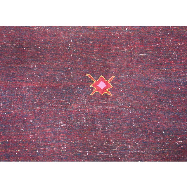 A simple but chic mid-20th century Persian Gabbeh kilim rug woven in crimson and indigo wool with a wonderful stylized...