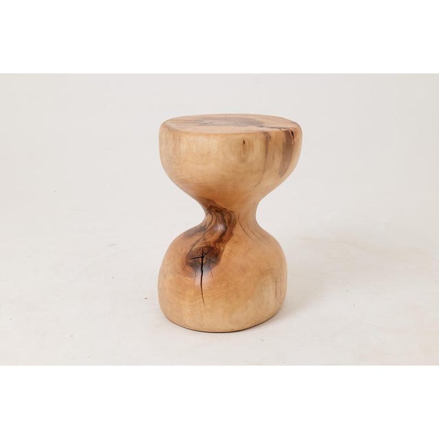 Carved from a single solid log, this side table has a refined sculptural presence that sets it apart from the more raw and...
