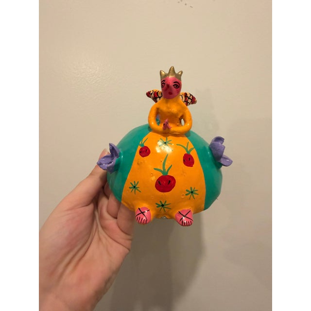 Dimensions: 6 x 6 x 3 inches (deep) Description: This handcrafted folk art mask, carved from a natural coconut shell,...