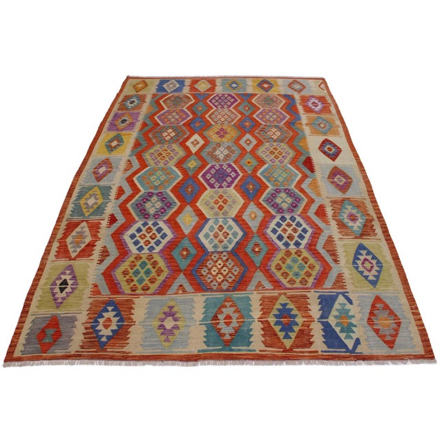 Add a touch of elegance to your home with this casual chic hand woven Tribal Kilim wool rug. Constructed on a loom by...