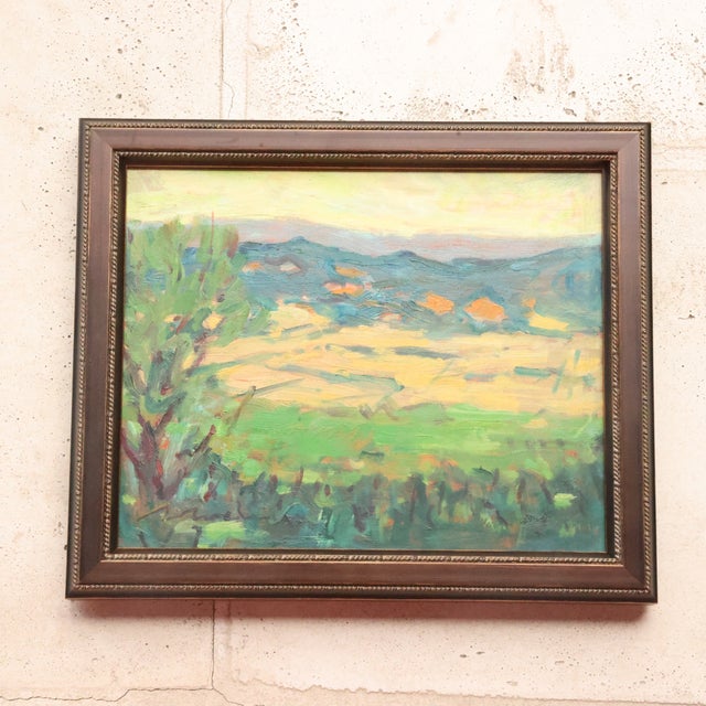 20th Century French Golden Field Painting depicts a bright countryside view with sunlit fields stretching toward distant...