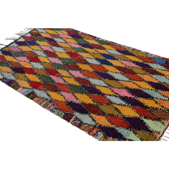 Hand-knotted in wool and circa 1950-1960, this 5x7 vintage Moroccan rug is believed to hail from the Azilal tribe. On the...