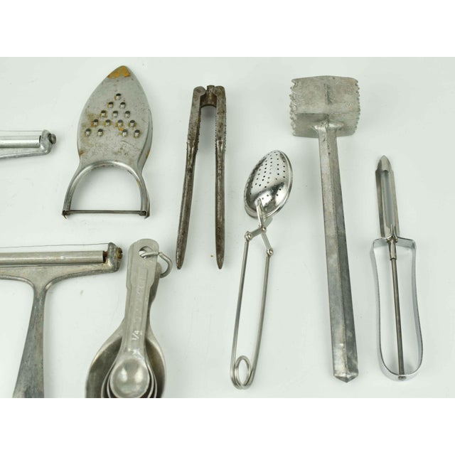 This curated 11-piece set of mid-century kitchenware features a rugged, industrial aesthetic crafted from cast aluminum,...