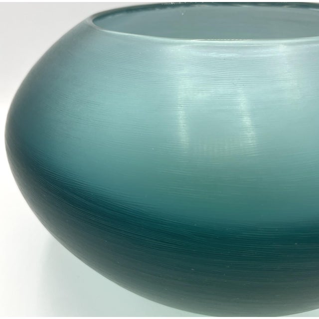 Oval vase with rounded shoulders in heavy aqua blue glass, featuring overlapping colors. The vases from Paolo Venini's...