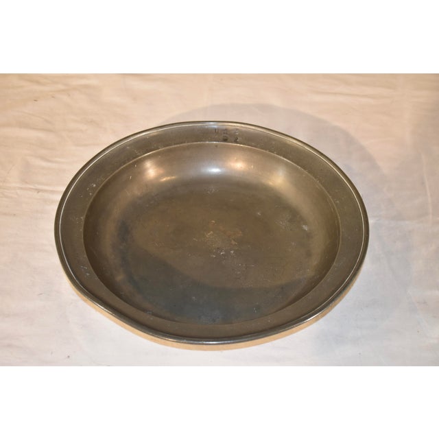 Early 19th century pewter bowl with touch marks on the rim and on the back is the impressed rose and crown with the...