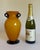 A striking hand-blown art-glass vase featuring a warm ochre-yellow exterior over an opaque white interior. Its full...