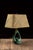 Mid-century modern ceramic table lamp featuring a sculptural open teardrop body finished in a rich glossy green glaze. The...