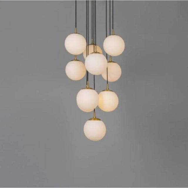 Globe cluster 10 chandelier by Schwung Dimensions: D 60 x H 155.4 cm Materials: Brass, opal glass Weight: 20.2 kg Finishes...