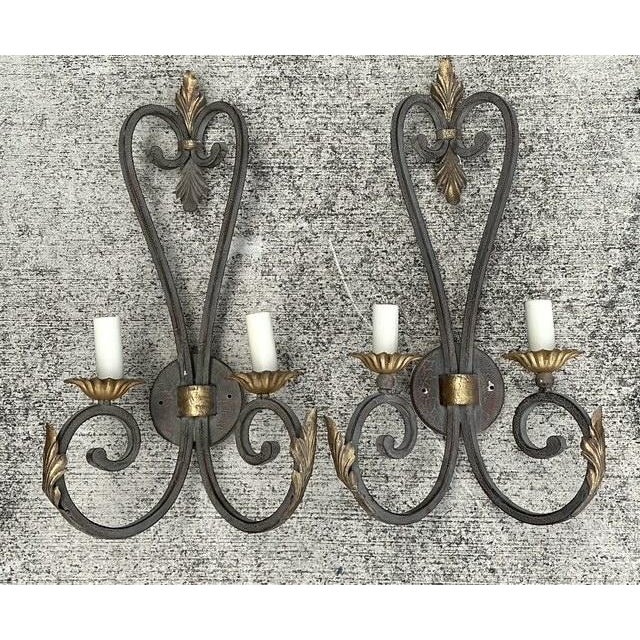 This exceptional pair of Spanish Revival wall sconces captures the bold, architectural elegance of mid-century...