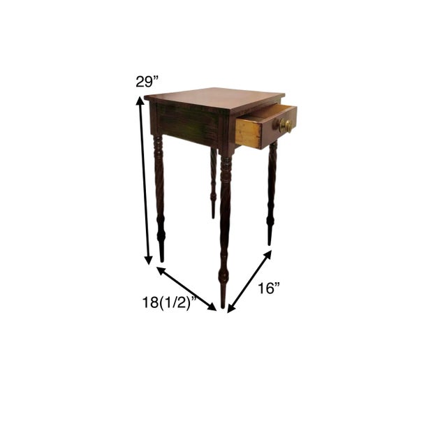 A classic mahogany one-drawer side table with a spindle leg and brass handle — the bedside or end table that goes with...