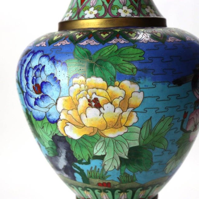 An antique Chinese cloisonné enameled vase, dating to approximately C1920. The piece features a design of two birds...