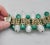 Metal Vintage Signed Napier Goldtone Green & White Moonglow Beaded Bracelet For Sale - Image 7 of 9