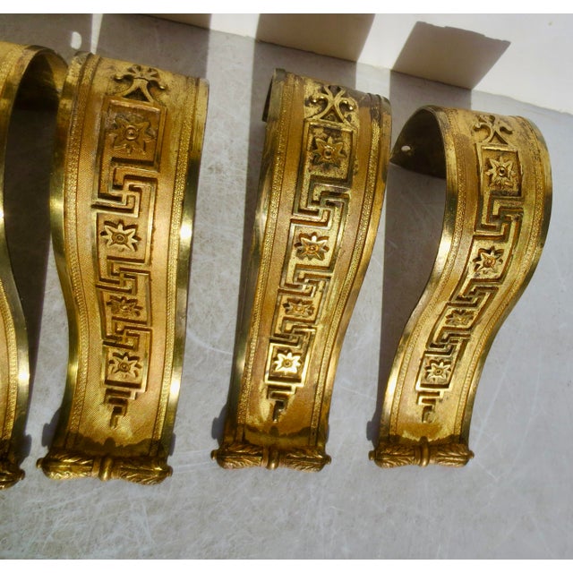 A set of 3 pairs, or 6 pieces of Napoleon III Curtian gilt bronze hold-back window curtain stays. Greek key and mesh...