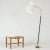 Striking floor lamp by Lisa Johansson-Pape, in a very cool, casually tilted design. Made from brass with stem wound with...