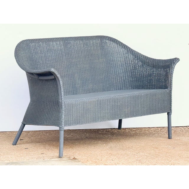 A fine Lloyd Loom settee or seating bench sofa, synonymous with classic English style, featuring a settee of woven wicker...