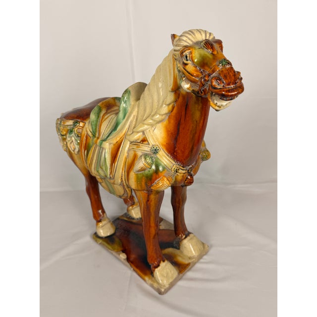 A large decorative Chinese sancai-glazed pottery figure of a caparisoned horse, produced in the Tang Dynasty style at a...