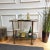 Beautiful and stylish 1960s Hollywood Regency Italian two-tier brass and smoked glass bar cart. A great piece that...