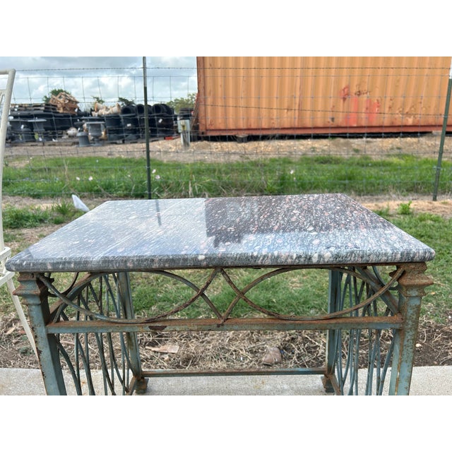 Wrought iron and marble side table. Offered is a handsome wrought iron and marble geometric side table. This Art Deco or...