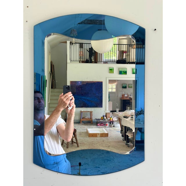 A fantastic and chic Italian art glass mirror in the distinct manner of Fontana Arte'. The bursting blue outer reflector...