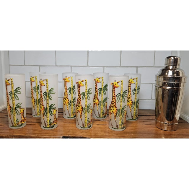This vintage set of frosted Tom Collins glass, features a charming giraffe and bamboo design, was created by Gay Fad...