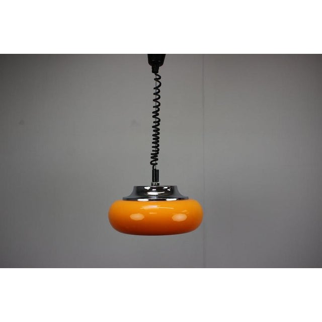 Exceptional 1970s Space Age pendant lamp by Harvey Guzzini for Meblo, showcasing one of the most recognizable visual...