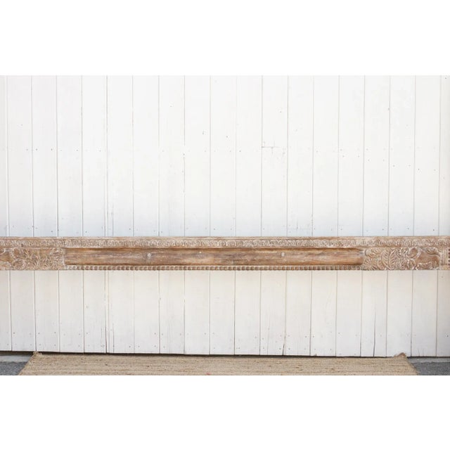 An architectural gem from India, this robust antique carved beam is hand carved from teak wood and is adorned with...