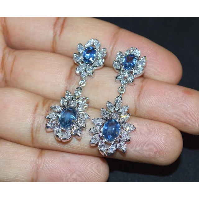 Certified natural 8.39CTS diamond and untreated blue sapphire 18K solid gold earrings. These earrings are loaded with...