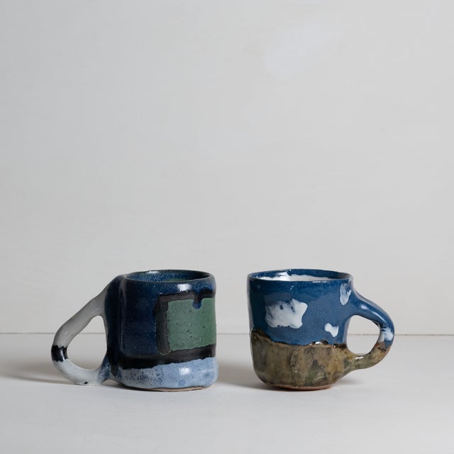 Two charming amateur pottery mugs signed by unknown artist, D.O.N. One earth-and-cloudscape, and one Rothko-esque abstract...