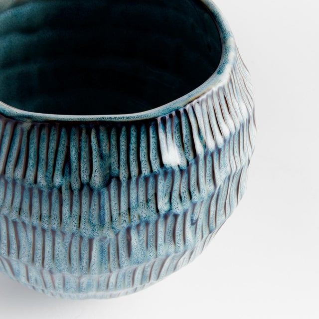 With a rounded form and unique hatched pattern, this sweet little pot has an artisans touch. Finished In a reactive glaze,...