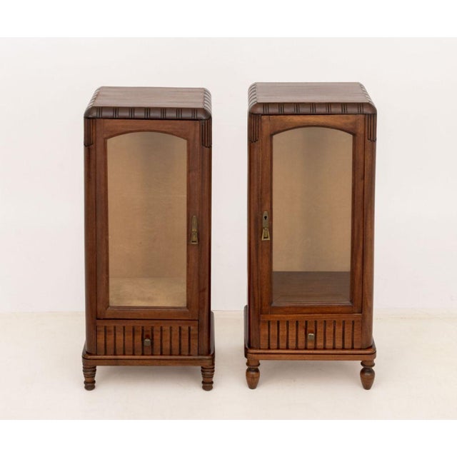Pair of Art Deco Walnut Display Cabinets, with beveled glass paneled doors. Taller: 38.5" H x 17" W x 14" D. Provenance:...