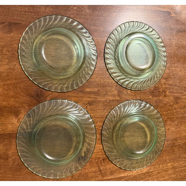 This is a set of four beautiful green glass saucers produced by Duncan & Miller featuring “Spiral Flutes“ pattern making...