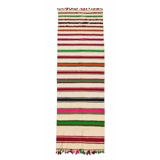 n exceptionally long vintage Moroccan Berber Kilim rug, handwoven in Morocco during the mid-20th century, circa 1960....