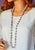 This vintage Chinese porcelain bead necklace features 50 beads with white and pink flower designs hand-painted on a light-...