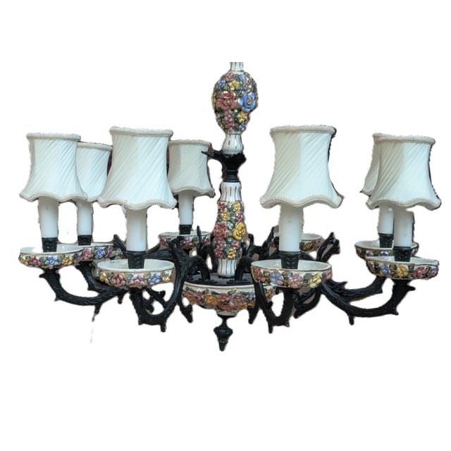 This chandelier features hand-painted ceramic and porcelain elements decorated with intricate flowers, typical of Faience...