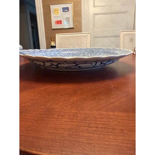 This Imari bowl/platter dates from the ealy 1900s and the blue and white design is typical of the period. The art in the...