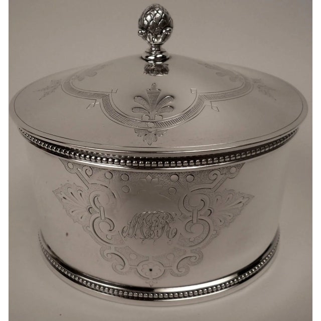 This hand chased heavy gauge sterling tea caddy was made in Boston by renowned makers Shreve and Stanwood, and weighs...