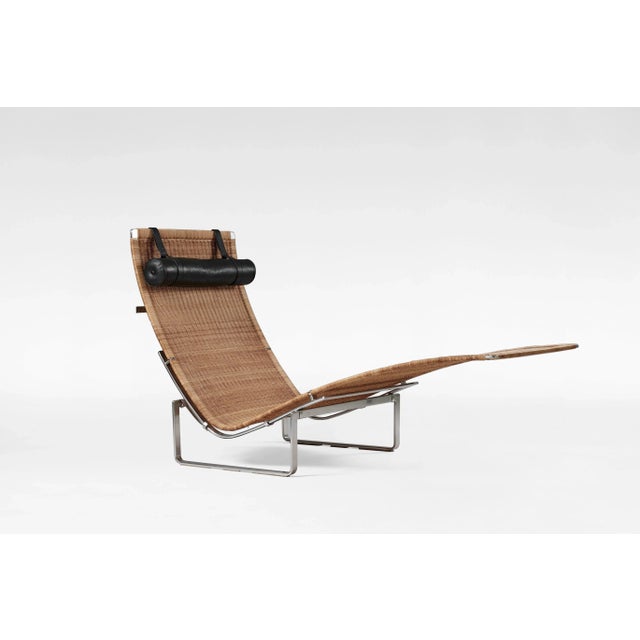 PK24 chaise lounge designed by Poul Kjærholm and manufactured by Fritz Hansen. Featuring a hand-woven wicker seat and a...