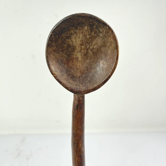 Zulu spoon from the early - mid 20th century. Dark, natural worn patina. Zulu spoons were carved by men only, out of a...